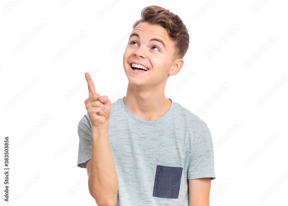 Cute teen boy pointing up, gesturing idea or doing number one gesture. Cute teen boy pointing up, gesturing idea or doing number one gesture.