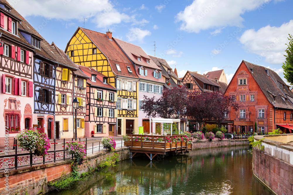 Picturesque view on Colmar street. Colourful architecture, canal and blue sky. Alsace, France