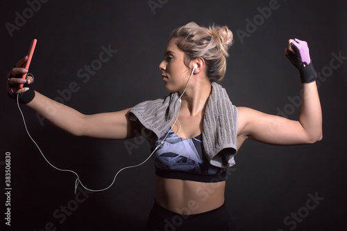Wallpaper Mural fitness woman poses with phone Torontodigital.ca