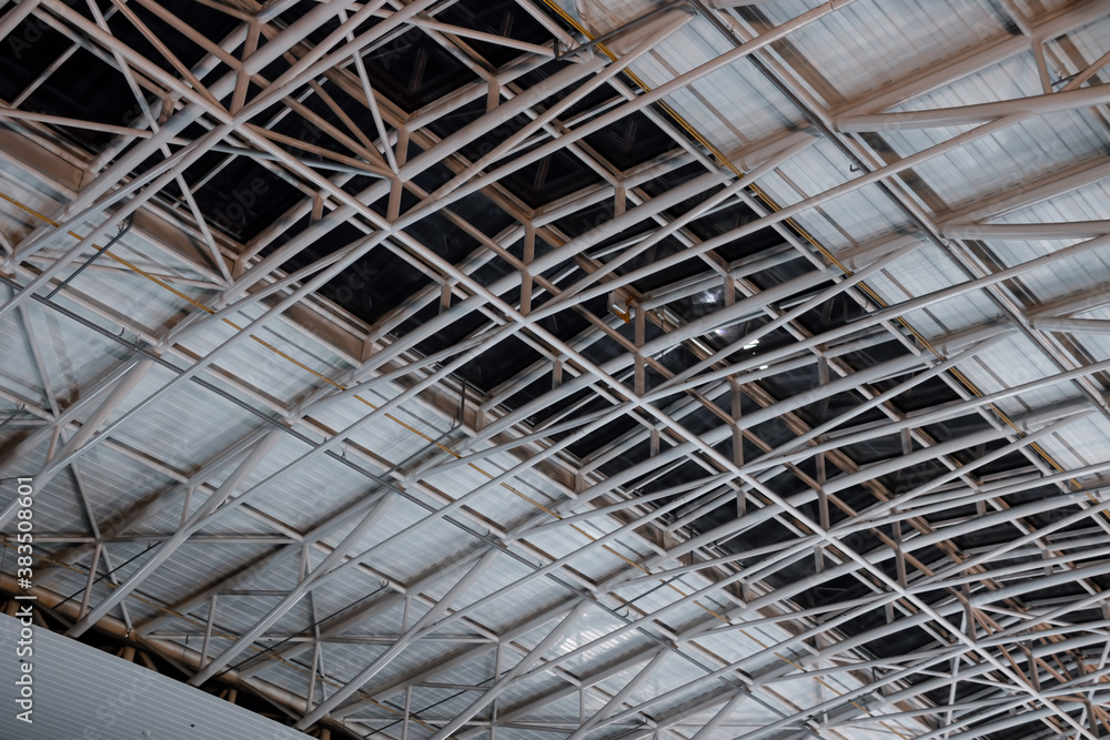 Metal pipe roof construction. Ceiling in a large room, lighting and ventilation. Materials. The interior of the room. Construction and maintenance concept.
