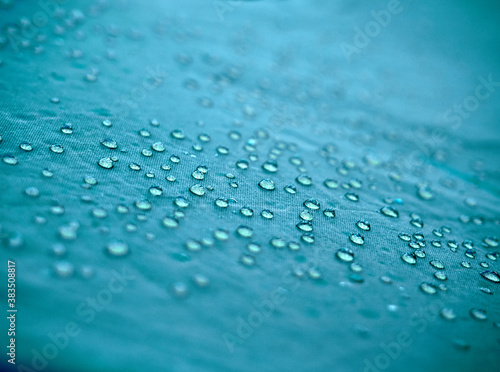 Water drops on blue fabric.
