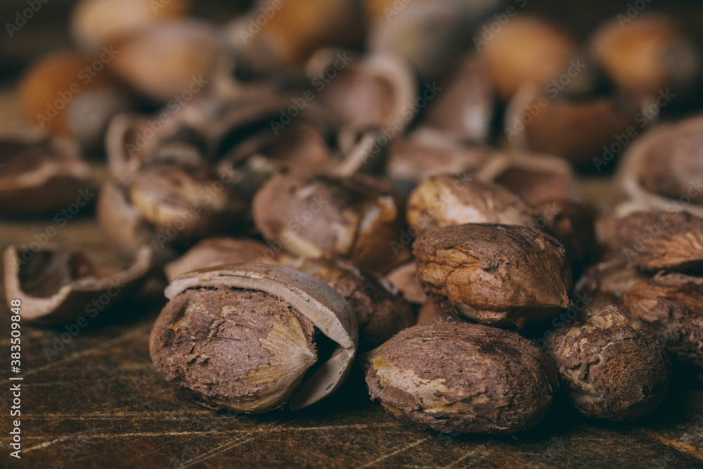 Whole nuts, shelled nuts and shells. Corylus avellana. Macro photo, close up, on wooden table. Whole nuts, shelled nuts and shells. Corylus avellana. Macro photo, close up, on wooden table.