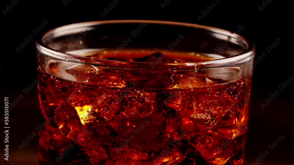 Glass of Cola with ice and bubbles. Glass of Cola with ice and bubbles.