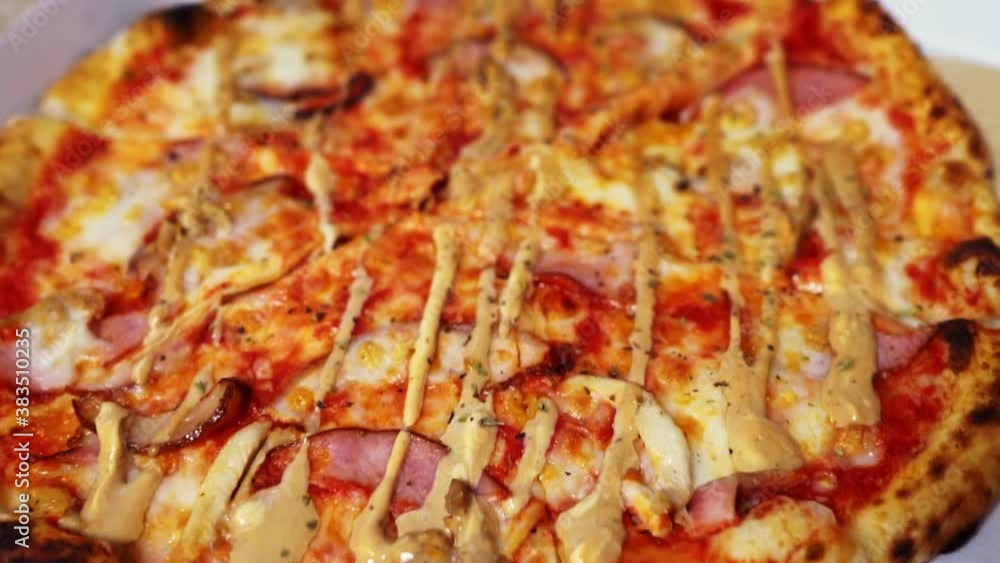 Pizza in cardboard box. The camera zooms in. Pizza in cardboard box. The camera zooms in.