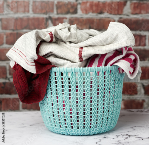laundry basket, brown brick wall background, close up