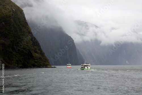 Cruise ship sailing towards a waterfall in Fiordland National Park - in the southwest of New Zealand’s South Island - famous for the glacier-carved fiords of Doubtful and Milford Sounds. © Jackie Davies