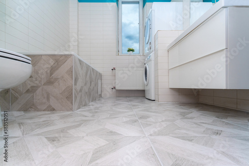 Bathroom after renovation. New stone tiles on the bath room floor. Home renovation and improvement concept. Nobody