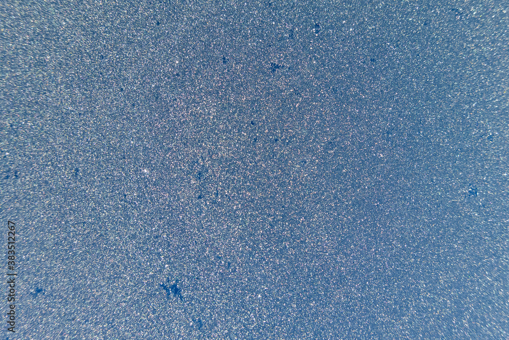 Abstract view of frost on window surface. Blue crystal frost texture. Cold winter background. Nobody
