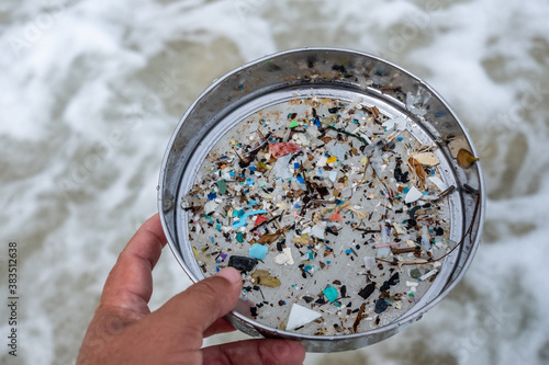 Environmentalists filter the microplastic waste contaminated with the seaside sand.