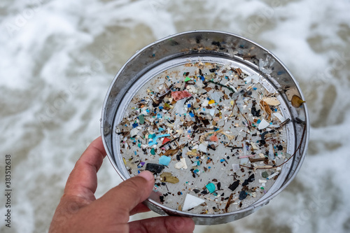 Environmentalists filter the microplastic waste contaminated with the seaside sand. photo
