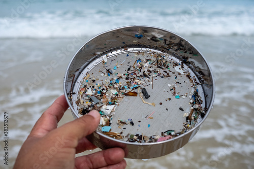 Environmentalists filter the microplastic waste contaminated with the seaside sand.