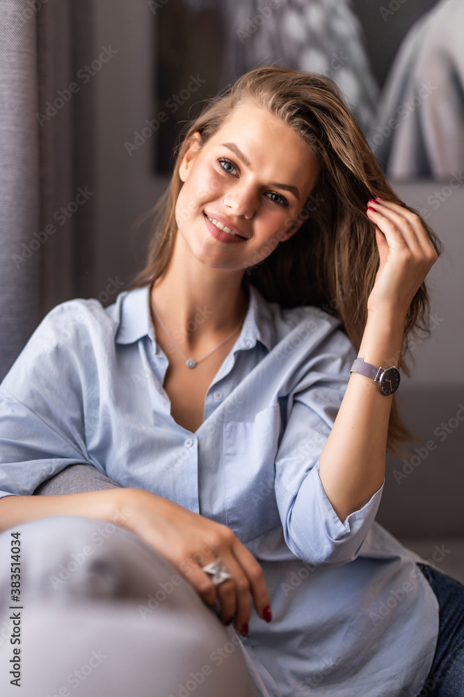Happy woman relaxing on comfortable soft sofa enjoying stress free weekend at home Happy woman relaxing on comfortable soft sofa enjoying stress free weekend at home