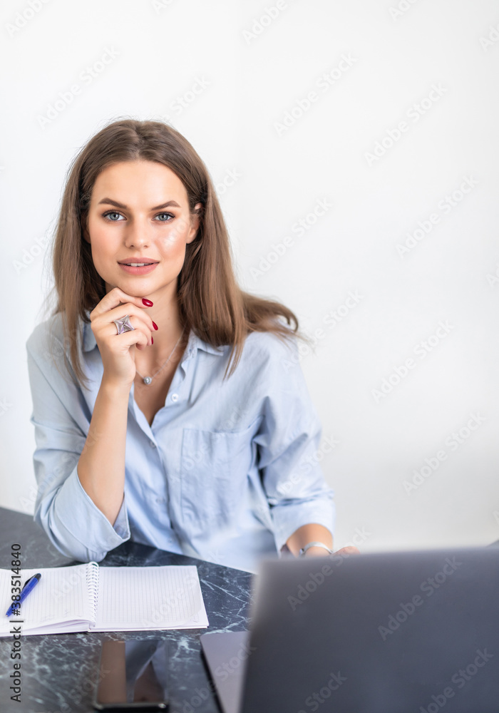 Young woman working from home office. Freelancer using laptop and the Internet workplace in cozy kitchen. Successful female business, self development. Lifestyle moment. Young woman working from home office. Freelancer using laptop and the Internet workplace in cozy kitchen. Successful female business, self development. Lifestyle moment.