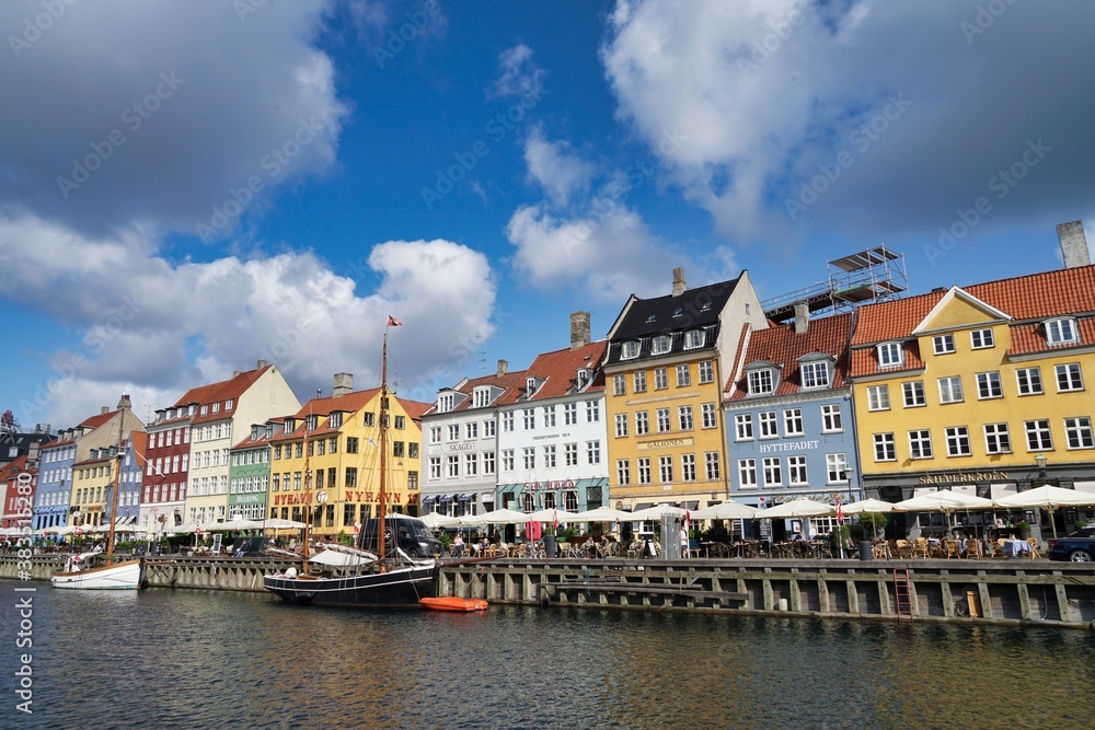 Copenhagen, Europe, colored houses in Nyhavn, promenade blue sky