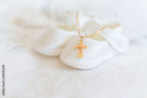 Fotografie, Obraz Clothes and a cross for the baby's christening. Selective focus.