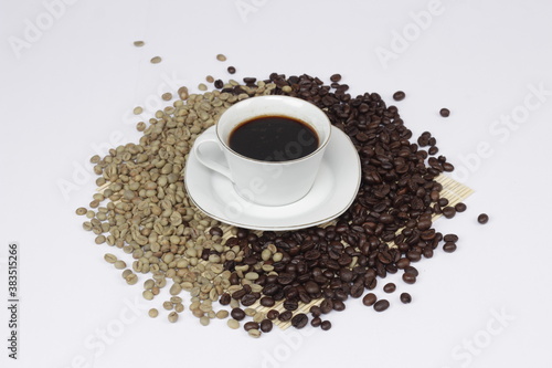 Serving black coffee on a white background  sprinkled with coffee beans.