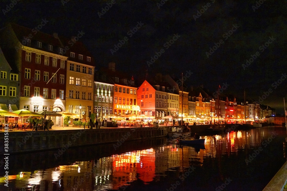 Copenhagen, Europe, Nyhavn promenade with restaurants, ships and houses, night