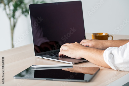Wallpaper Mural Man working on computer devices at home. Torontodigital.ca
