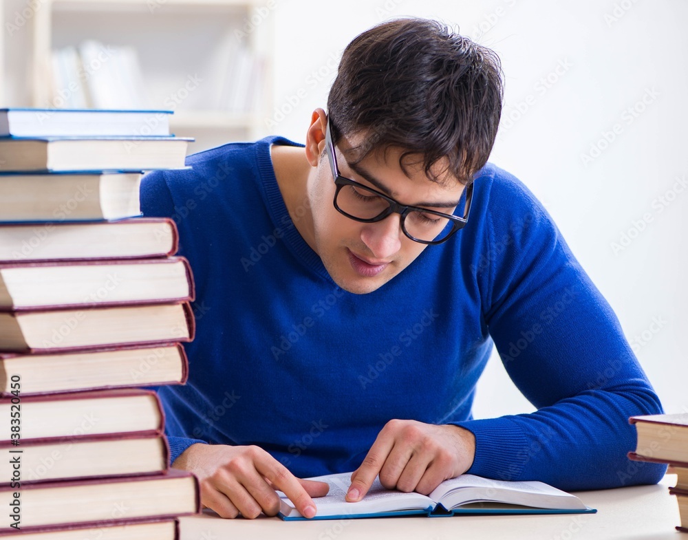 Male student preparing for exams in college library Male student preparing for exams in college library
