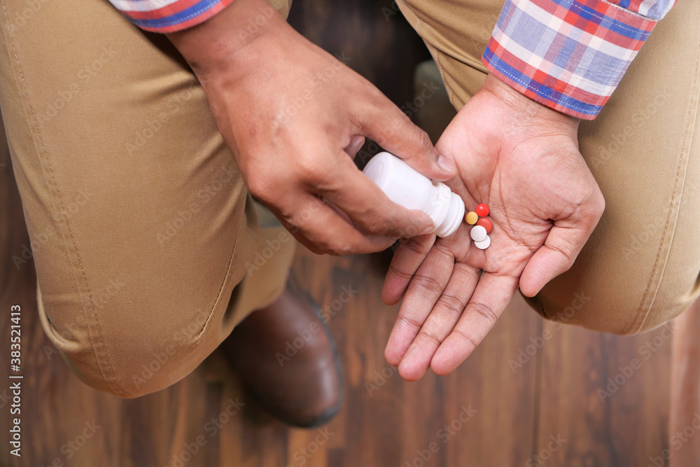 Close up of man hand taking medicine Close up of man hand taking medicine