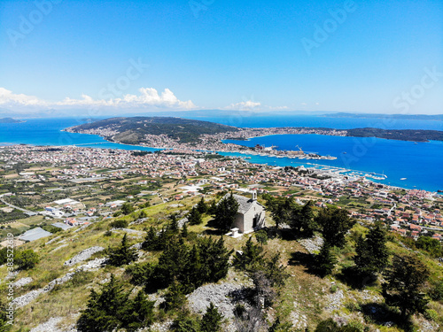 SEGET GORNJI, CROATIA - June 2020 - Aerial view of Sutilija hill. The church of St. Elijah church and Seget Valley and the Central Dalmatia Islands in distance.