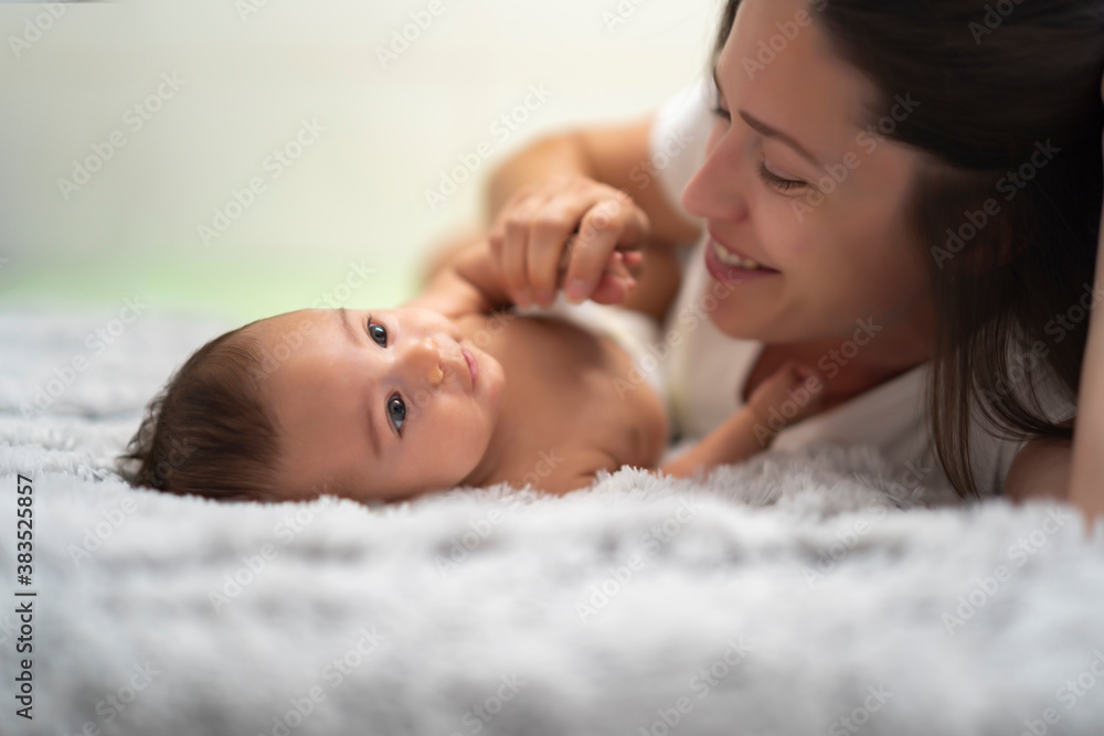 mother playing with her baby in bed mother playing with her baby in bed