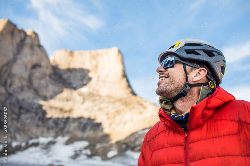 Smiling side view portrait of mountain climber below summit. Smiling side view portrait of mountain climber below summit.