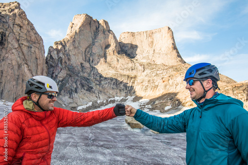 Two climber fist bump after a successful climb photo