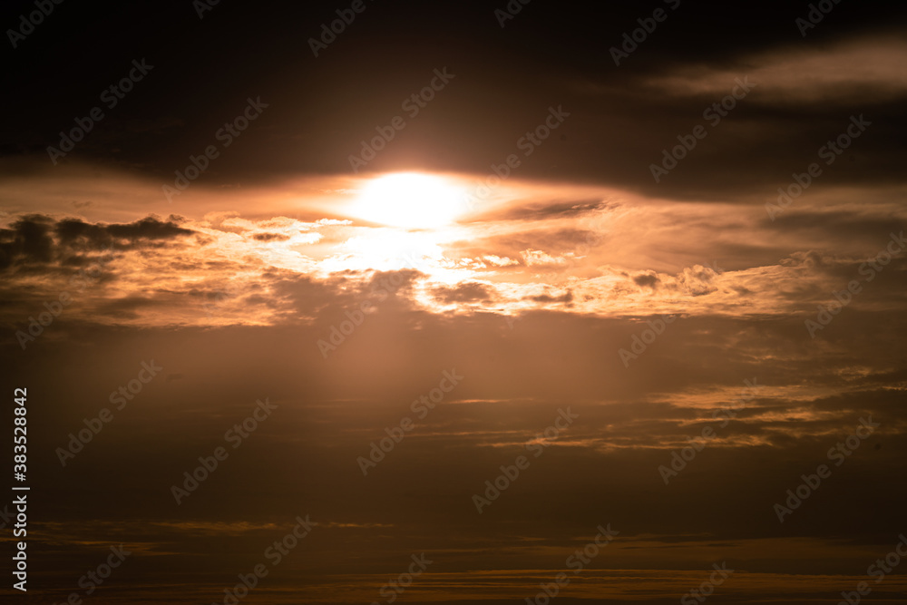 Fototapeta premium Dramatic orange sunlight photo during sunset period with cloudy sky environment. Abstract background from natural photo.