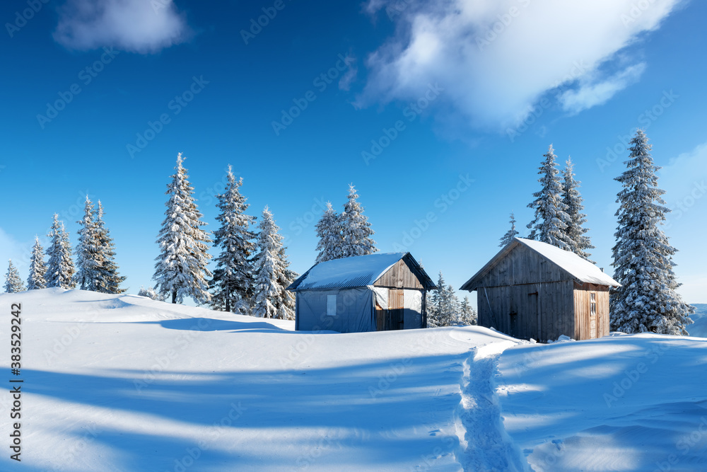 Fantastic winter landscape with wooden house in snowy mountains. Christmas holiday concept Fantastic winter landscape with wooden house in snowy mountains. Christmas holiday concept
