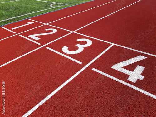 Red running racetrack on the stadium. Red running tracks in the stadium. Empty sport stadium. Starting Line of Track Running Lanes in stadium