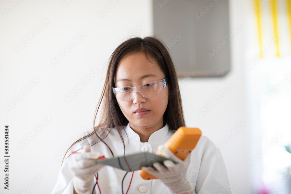 scientist female with sample and tool in a lab scientist female with sample and tool in a lab