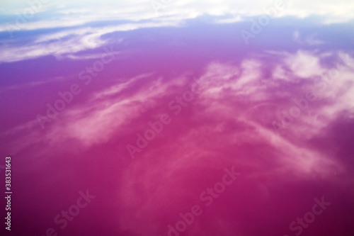 Abstract view of pink lake salt water and clouds reflection from drone. Creative nature color concept. Top view background