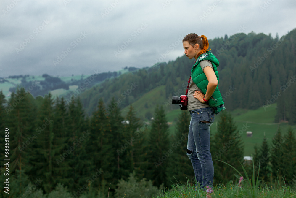 girl photographer in the carpathian mountains shoots a landscape girl photographer in the carpathian mountains shoots a landscape