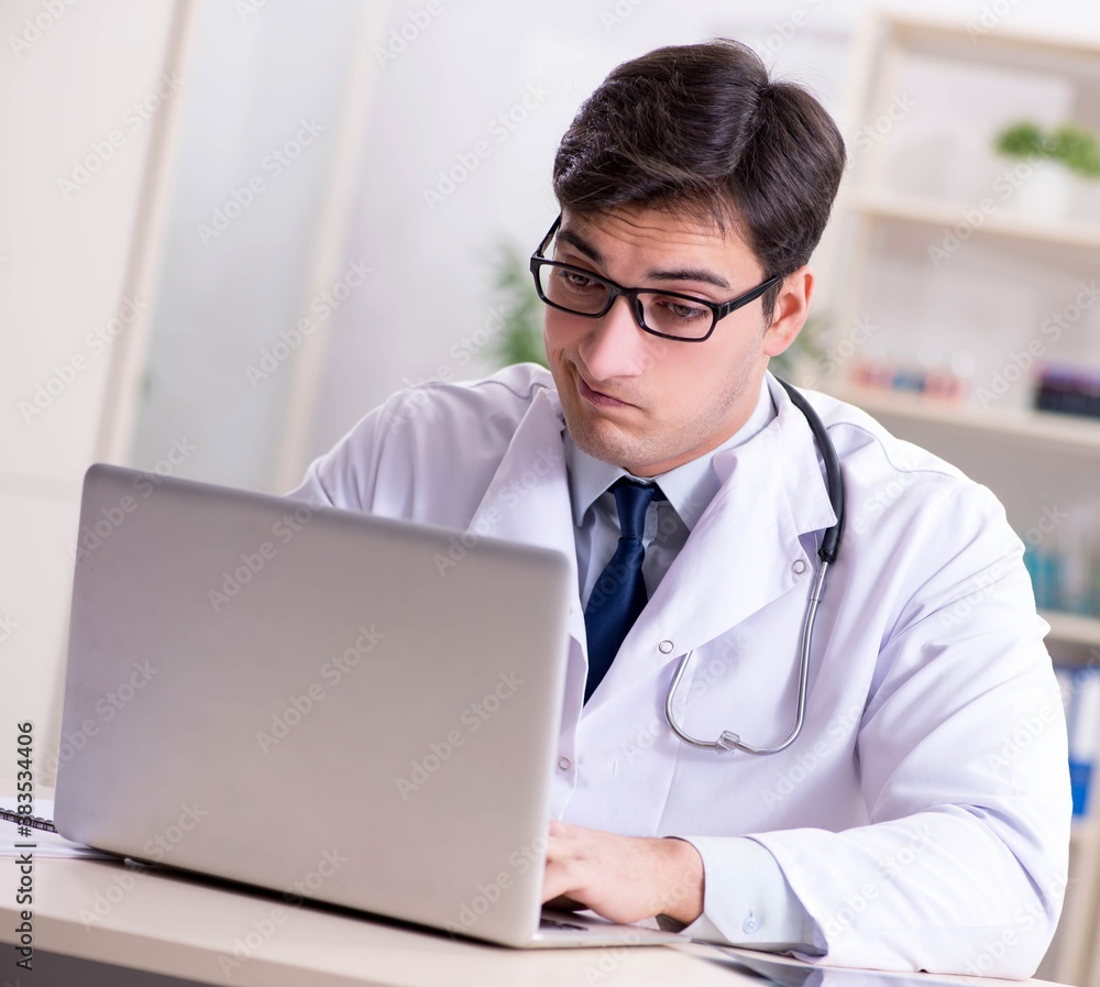 Young doctor sitting in the office Young doctor sitting in the office