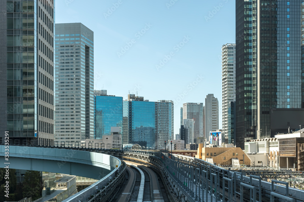 High speed Tokyo skyline with skyscrapers and blue clear sky , at day time Japan.