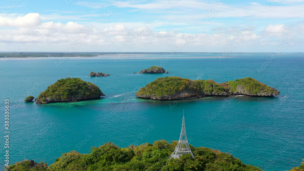 Islands in blue water covered with vegetation with beaches and bays where tourists rest. Hundred Islands National Park, Pangasinan, Philippines. Alaminos. Summer and travel vacation concept