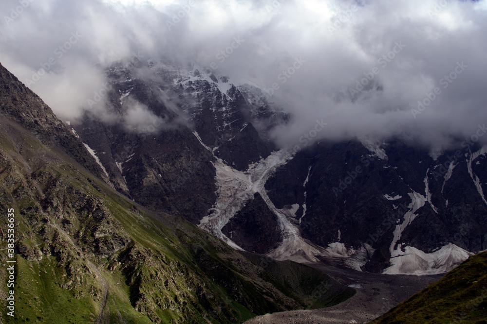 Mountain peaks with glaciers.
View of Mount Donguzorun from the slopes of Mount Cheget. Terskol, Caucasus, Russia. Mountain peaks with glaciers.
View of Mount Donguzorun from the slopes of Mount Cheget. Terskol, Caucasus, Russia.