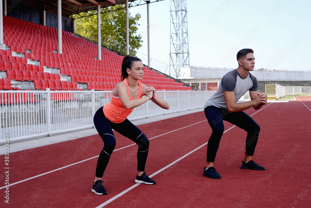 Young couple exercise together on the athletic track