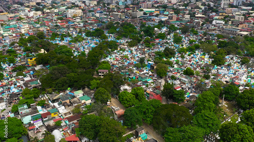 Famous cemetery in the city of Manila, where people live among the graves and crypts top view. Travel concept.