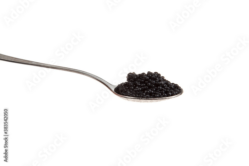 black caviar in spoon, isolated on white