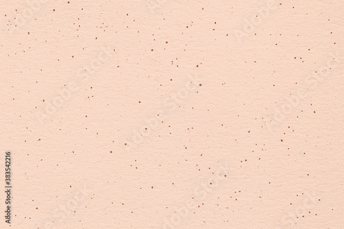 Pink earthy blush texture. Peachy handcrafted background with dots and flakes.