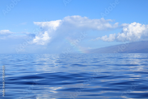 Rainbow over Pacific Ocean by Lahaina island.