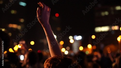 arm of a person moving to the rhythm of a music concert photo