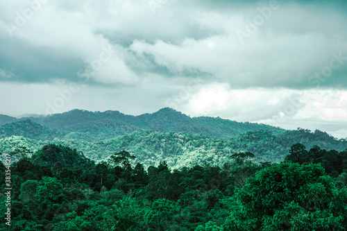 Top view of landscape dark green mountain with raining cloudy sky