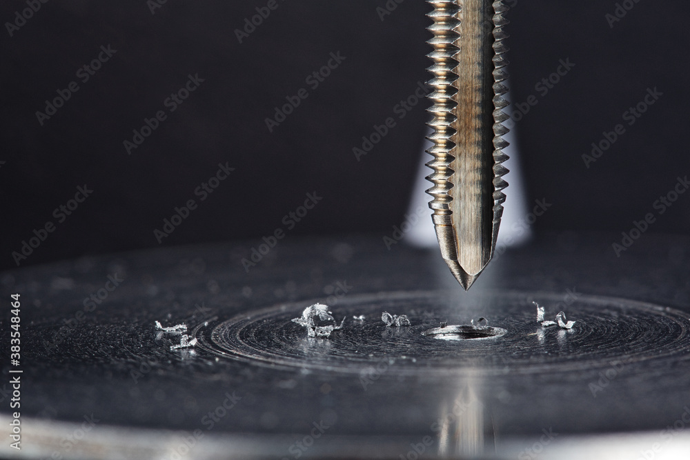 Obraz premium Thread tap. Tap drill steel billet. Working cutter.