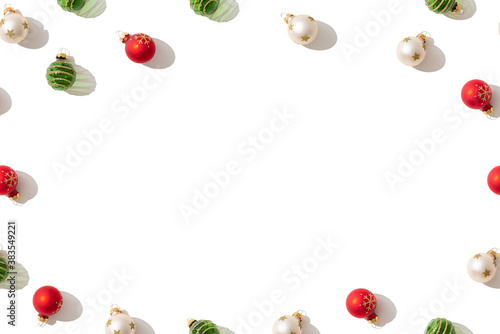 Christmas background. Christmas balls, red, green and gold on white background. Flat lay, top view, copy space. Greeting card, package, invitation trendy christmas new year design.