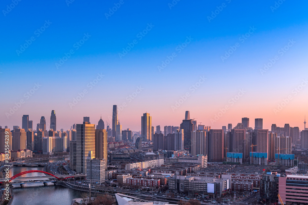 Sunset waterfront downtown skyline with Tianjin high-rise building cityscape at Haihe riverside, , Tianjin city, China