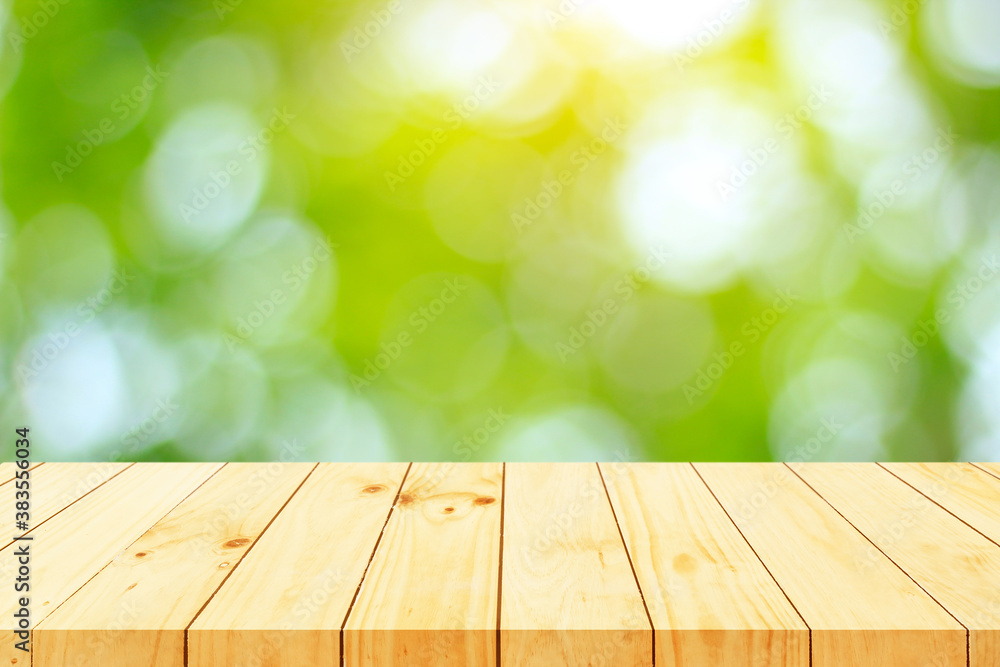 Wood floor with blurred trees of nature park background and summer season, product display montage Wood floor with blurred trees of nature park background and summer season, product display montage