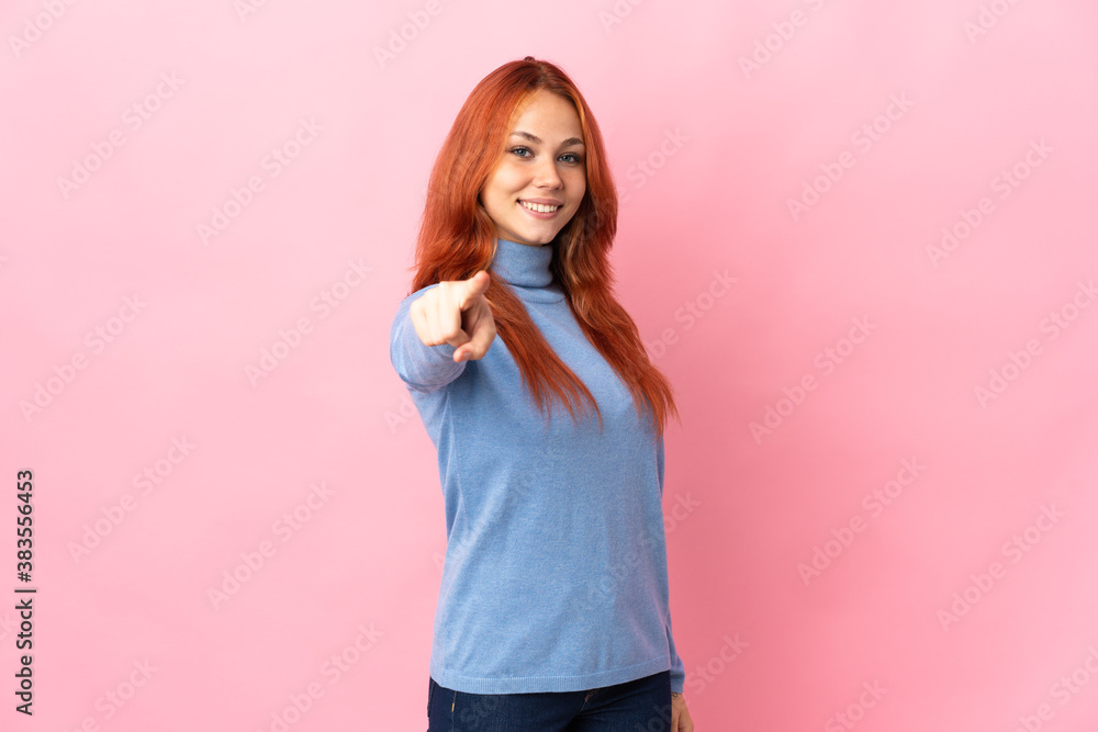 Teenager Russian girl isolated on pink background pointing front with happy expression Teenager Russian girl isolated on pink background pointing front with happy expression